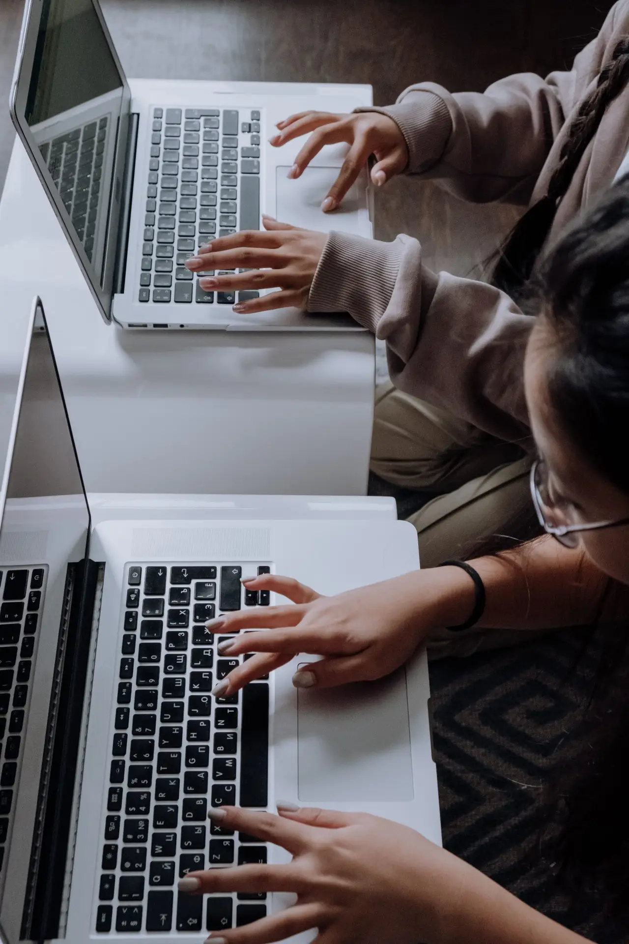 Two girls typing on laptops, Digital Skills