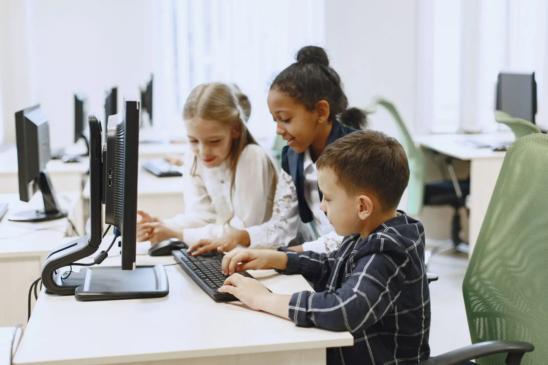 3 kids using a keyboard and computer, Digital Skills