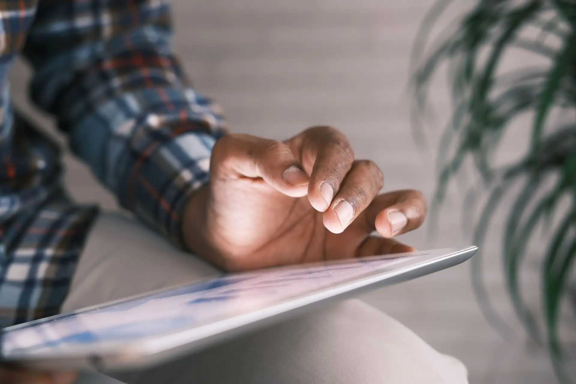hand hovering over tablet/ipad